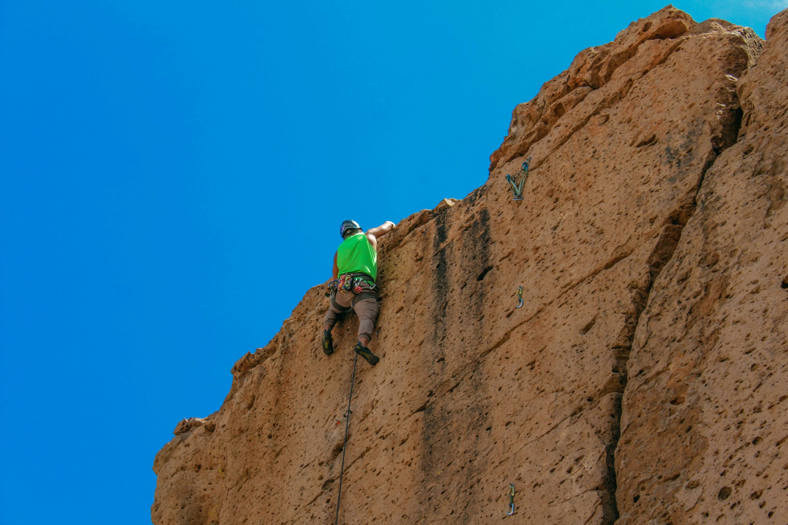 A climber struggling due to improper piton usage