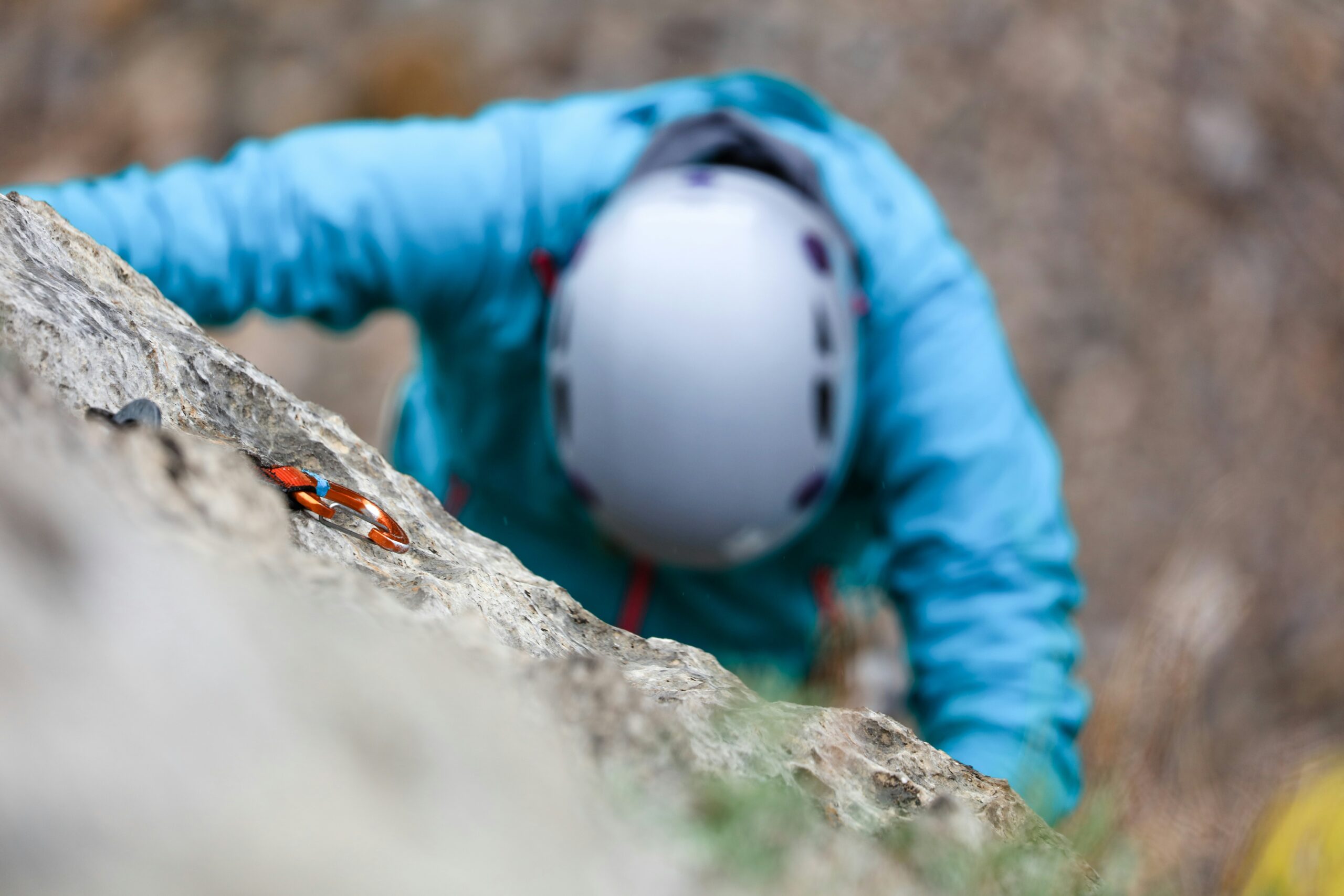 Climber inspecting a climbing piton for wear and tear