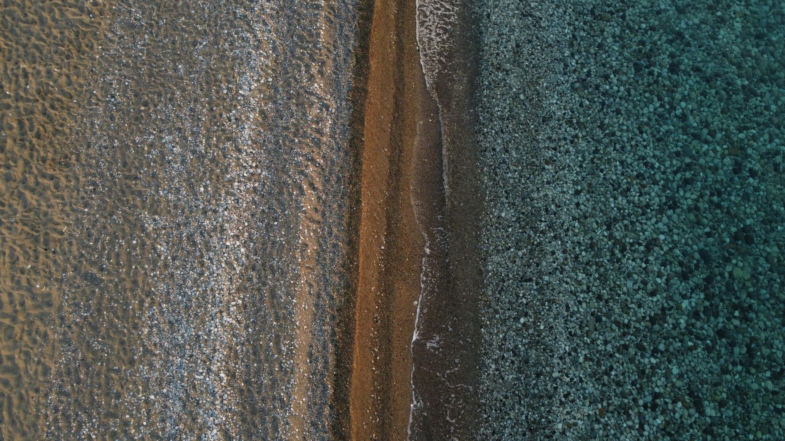 Closeup showing various lengths and materials of ice screw pitons
