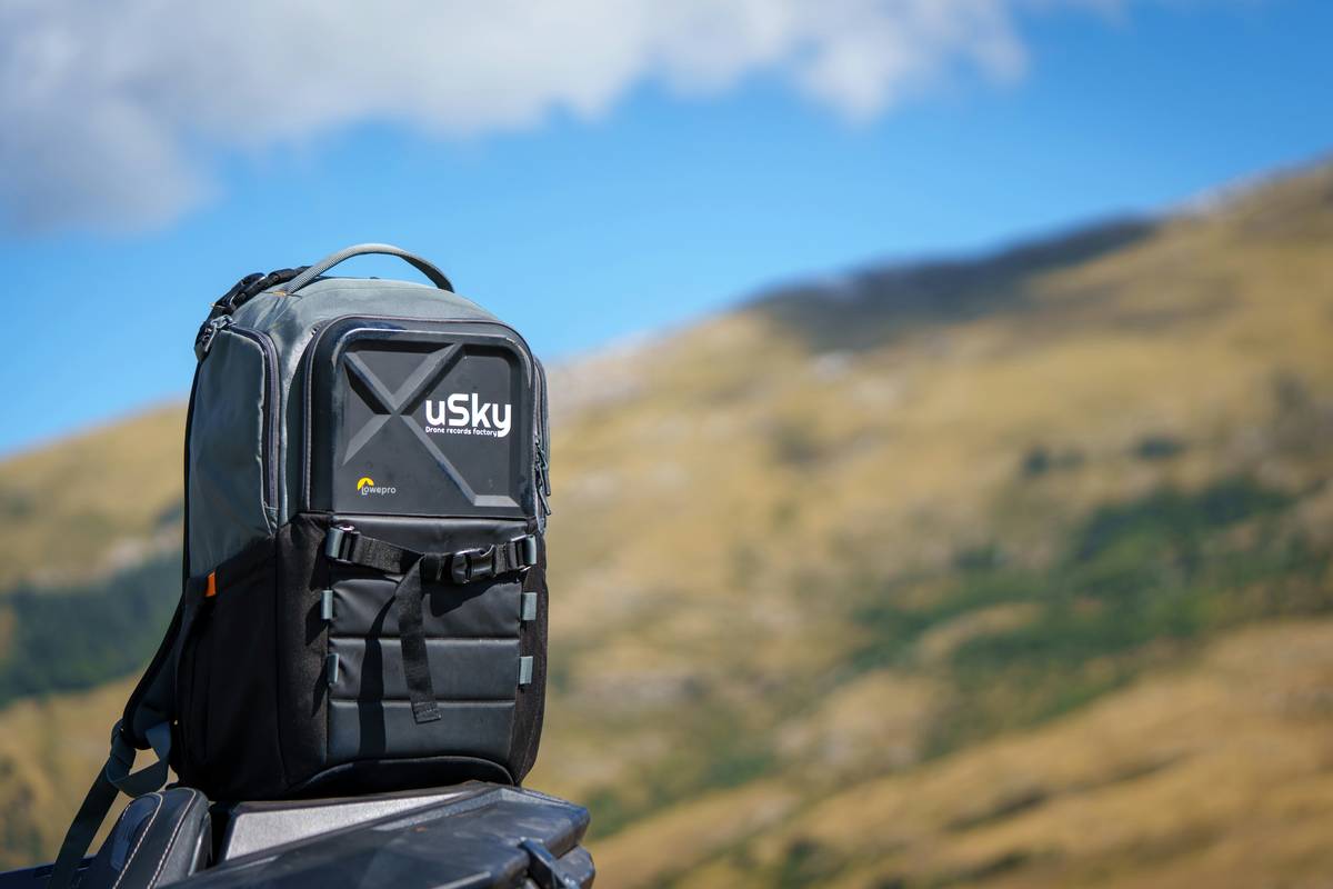 Climber holding a brass nut tool near a piton