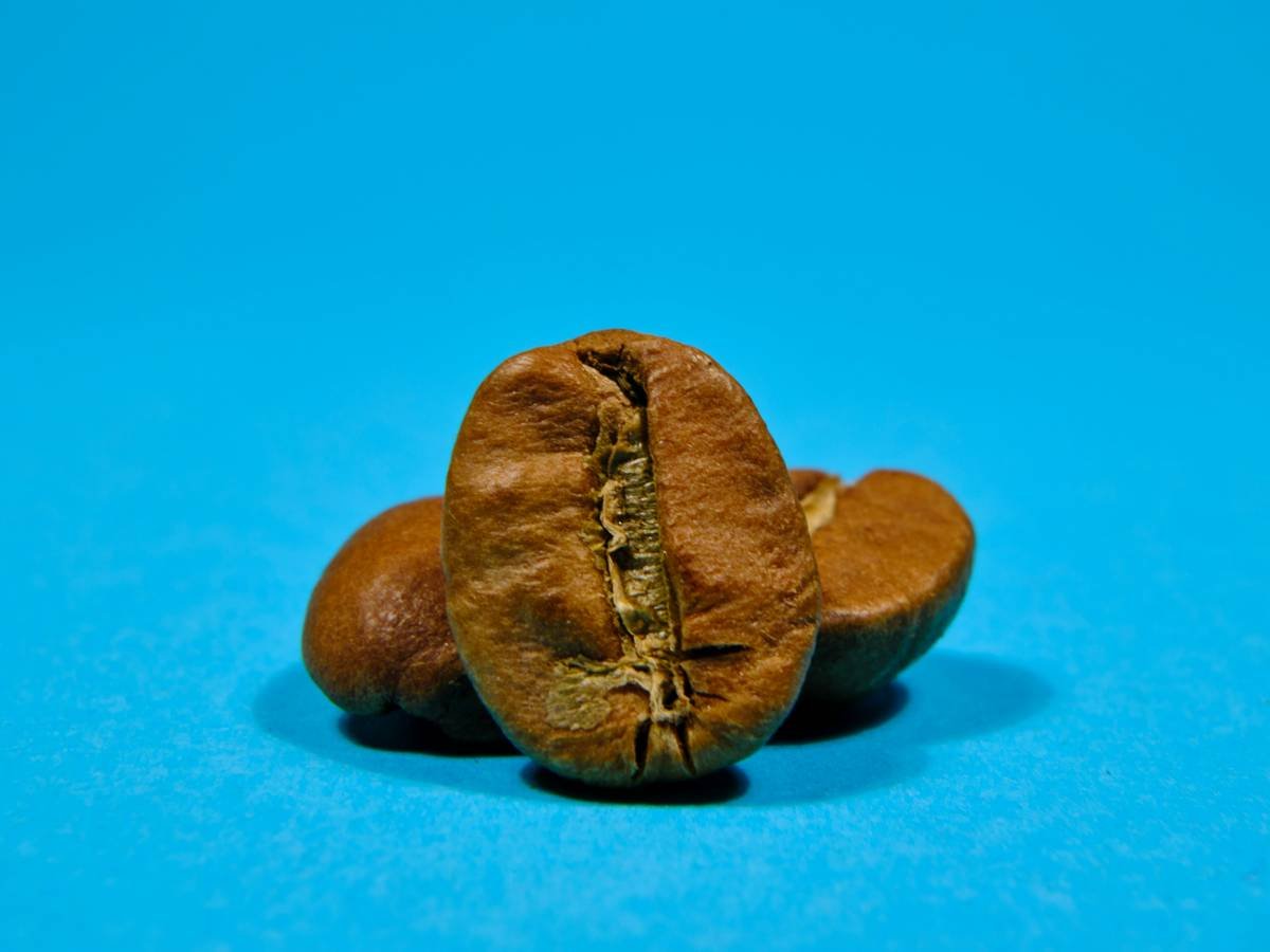 Climber struggling to extract a rusted piton stuck in rock
