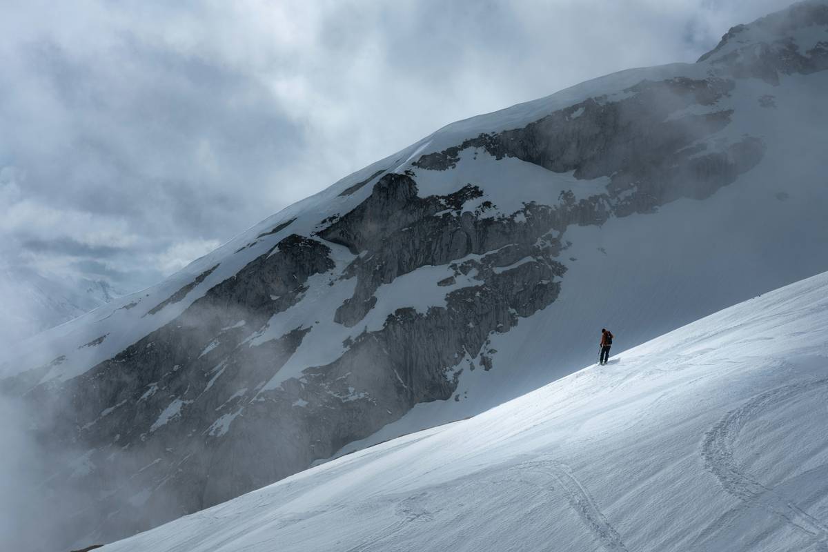 Climber testing piolet traction on simulated ice wall