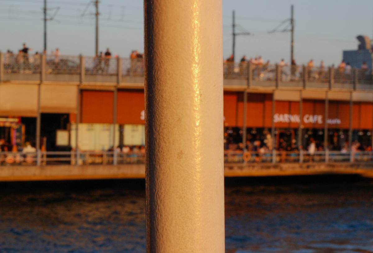 Close-up shot showing proper technique for hammering rappel piton anchor steel